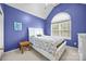Blue bedroom featuring a queen size bed, arch window, and lots of natural light at 6533 Derby Nw Ln, Concord, NC 28027