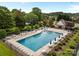 Expansive community pool with ample lounge seating, tables and landscaped grounds, perfect for relaxation and recreation at 6533 Derby Nw Ln, Concord, NC 28027
