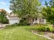 Inviting two-story home with lush green lawn, mature trees, and a charming front porch at 6533 Derby Nw Ln, Concord, NC 28027