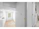 Upstairs hallway showcases doorways and a glimpse of unfinished attic space and a bathroom at 6533 Derby Nw Ln, Concord, NC 28027
