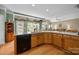 Spacious kitchen with wooden cabinets, a large island, and modern black appliances at 6533 Derby Nw Ln, Concord, NC 28027