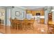 Open kitchen with a large island, hardwood floors, and a breakfast bar with seating at 6533 Derby Nw Ln, Concord, NC 28027