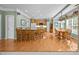 Open kitchen and dining area with hardwood floors, a center island, and wooden cabinetry at 6533 Derby Nw Ln, Concord, NC 28027