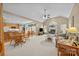 Open-concept living room with fireplace, vaulted ceiling, and seamless flow into dining area at 6533 Derby Nw Ln, Concord, NC 28027