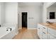 Bright bathroom with a soaking tub, walk-in closet, and granite countertops on the vanity at 6618 Alexander Rd, Charlotte, NC 28270