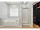 Primary bathroom with a soaking tub, glass shower, and a custom walk-in closet at 6618 Alexander Rd, Charlotte, NC 28270