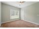 Bedroom featuring neutral walls, carpet flooring, and a ceiling fan with natural light at 6618 Alexander Rd, Charlotte, NC 28270