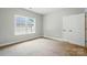 Bedroom featuring neutral walls, carpet flooring, and a closet at 6618 Alexander Rd, Charlotte, NC 28270