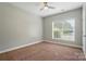 Bright bedroom featuring neutral walls, carpet flooring, and a ceiling fan at 6618 Alexander Rd, Charlotte, NC 28270