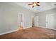 Neutral bedroom with a glimpse into the ensuite bathroom and walk-in closet at 6618 Alexander Rd, Charlotte, NC 28270