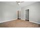 Bedroom featuring neutral walls, carpet flooring, a ceiling fan and an open closet space at 6618 Alexander Rd, Charlotte, NC 28270