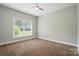 Bedroom featuring neutral walls, carpet flooring, and a ceiling fan with natural light at 6618 Alexander Rd, Charlotte, NC 28270