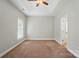 Spacious bedroom featuring a trey ceiling, neutral walls, carpeted floors, and natural light at 6618 Alexander Rd, Charlotte, NC 28270