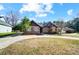 Inviting brick home with manicured lawn and attached garages offer convenience and curb appeal at 6618 Alexander Rd, Charlotte, NC 28270