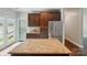 Well-lit kitchen features granite countertops, stainless steel fridge, and dark wood cabinetry at 6618 Alexander Rd, Charlotte, NC 28270