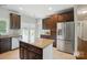 Spacious kitchen with a large island, stainless steel appliances, and dark wood cabinets at 6618 Alexander Rd, Charlotte, NC 28270