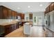 Beautiful kitchen features tile backsplash, center island, stainless steel appliances, and tiled flooring at 6618 Alexander Rd, Charlotte, NC 28270
