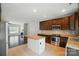 Modern kitchen flows seamlessly to the living area, featuring granite countertops, stainless appliances, and tile floor at 6618 Alexander Rd, Charlotte, NC 28270