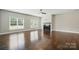 Spacious living room with hardwood floors, fireplace, and large windows that provide natural light at 6618 Alexander Rd, Charlotte, NC 28270