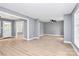 Bright living room with light wood floors, neutral walls, a ceiling fan and multiple windows at 7118 April Ridge Ln, Charlotte, NC 28215