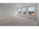 Bright, spacious bedroom features three windows offering neighborhood views and plush carpet at 725 Sirius Ln # 90, York, SC 29745