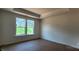 Bedroom showcasing recessed ceiling detail and a large window with a view of the backyard at 725 Sirius Ln # 90, York, SC 29745