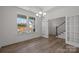 Open dining room with large windows, wood-look floors, and view of staircase at 725 Sirius Ln # 90, York, SC 29745