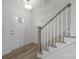 Bright entryway with wood-look floors, staircase with gray wood trim, and white front door at 725 Sirius Ln # 90, York, SC 29745