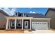 Charming single-story home featuring a covered front porch and an attached garage at 725 Sirius Ln # 90, York, SC 29745