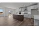 Open kitchen with large island, white cabinets, and stainless steel appliances at 725 Sirius Ln # 90, York, SC 29745