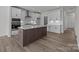 Spacious kitchen with island, white cabinets, and stainless appliances at 725 Sirius Ln # 90, York, SC 29745