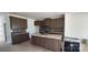 Spacious kitchen with dark wood cabinets, a kitchen island, and stainless steel appliances at 725 Sirius Ln # 90, York, SC 29745