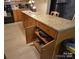 Kitchen island with granite countertops, wooden cabinets, and unique storage features for cookware at 746 Sinclair Dr, Monroe, NC 28112