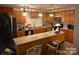 Well-lit kitchen featuring wooden cabinets, a tile backsplash, stainless steel appliances, and center island at 746 Sinclair Dr, Monroe, NC 28112