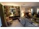 Cozy living room with a brick fireplace and custom built-in shelving offering storage and display space at 746 Sinclair Dr, Monroe, NC 28112