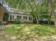 Beautiful backyard with a well-maintained lawn, patio seating, and mature trees at 828 Colville Rd, Charlotte, NC 28207