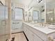 Elegant bathroom featuring double sinks, marble countertops, and a glass-enclosed shower at 828 Colville Rd, Charlotte, NC 28207