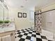 Elegant bathroom with checkered tile floor, marble countertop, and shower and tub combination at 828 Colville Rd, Charlotte, NC 28207
