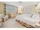 Inviting bedroom featuring a floral bedspread, a comfortable seating area, and natural light at 828 Colville Rd, Charlotte, NC 28207