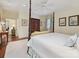 Spacious bedroom with a four-poster bed, sitting area, and neutral decor at 828 Colville Rd, Charlotte, NC 28207