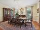 Formal dining room with a chandelier, elegant table setting, and hardwood floors with rug at 828 Colville Rd, Charlotte, NC 28207