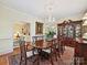 Dining room showcasing a chandelier, hardwood floors, and view to the adjacent living room at 828 Colville Rd, Charlotte, NC 28207