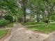 Beautifully landscaped home with a long driveway and mature trees at 828 Colville Rd, Charlotte, NC 28207
