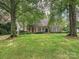 Inviting brick home with well-manicured lawn and mature trees at 828 Colville Rd, Charlotte, NC 28207
