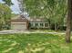 Charming home featuring an attached two car garage and lush green lawn at 828 Colville Rd, Charlotte, NC 28207
