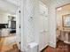 Hallway leading to a kitchen and a bathroom with a white storage cabinet in the center at 828 Colville Rd, Charlotte, NC 28207
