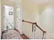 Bright hallway with hardwood floors, a white wooden railing, and access to other rooms at 828 Colville Rd, Charlotte, NC 28207