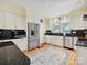 Bright kitchen features white cabinets, stainless steel appliances, and a stylish rug at 828 Colville Rd, Charlotte, NC 28207