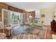 Charming living room with exposed brick, French doors, and views into an adjacent sitting area at 828 Colville Rd, Charlotte, NC 28207