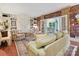 Comfortable living room with a brick accent wall, built-in bookshelves, and access to the sunroom at 828 Colville Rd, Charlotte, NC 28207
